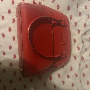 Vibrant Red Glossy Shoulder Bag with Circular Design